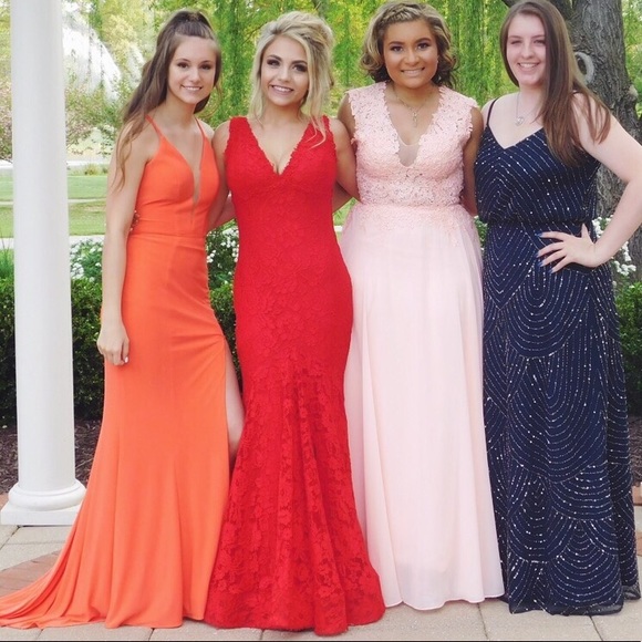 red prom dress with roses at the bottom